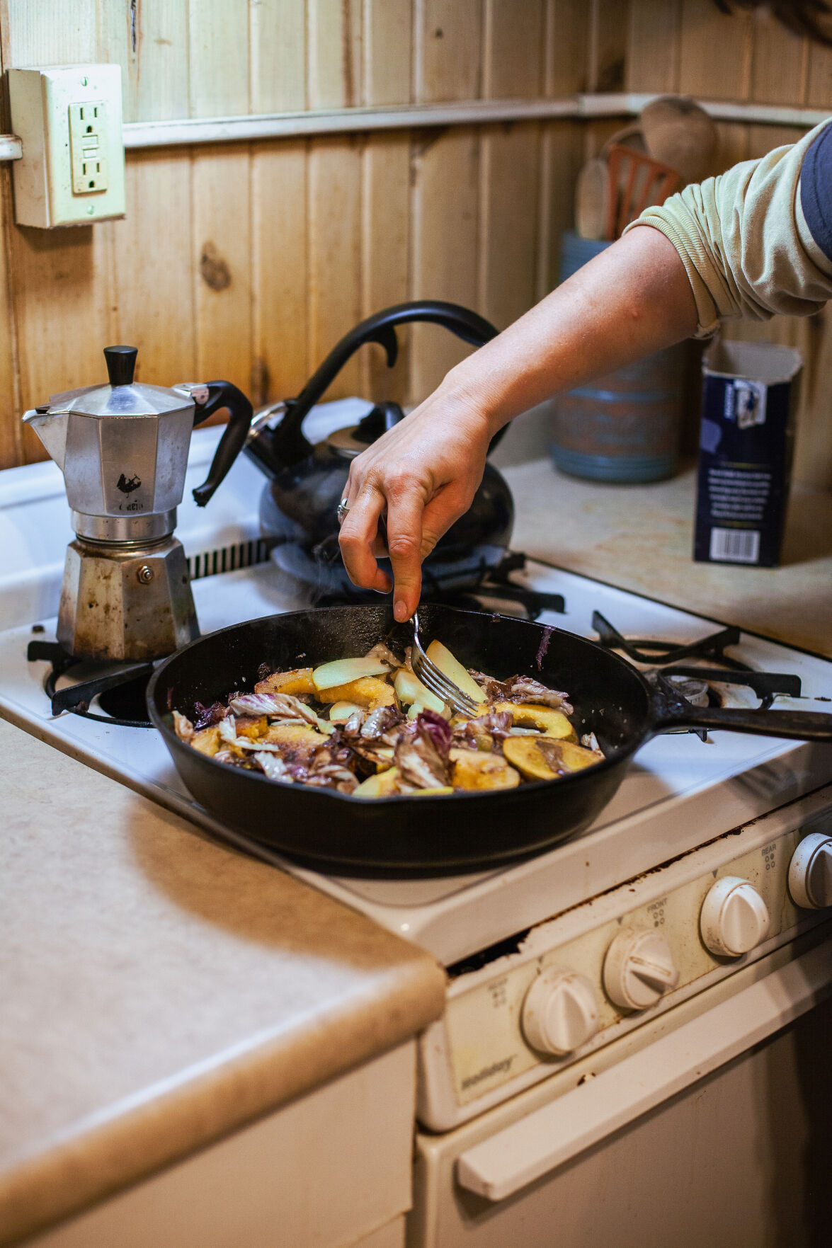 Michelle La Fata sautés local acorn squash, cabbage and apples in a cast iron skillet